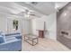 Bright living room featuring a modern fireplace, wood-look tile floors and white brick accents at 17401 N 16Th Ave, Phoenix, AZ 85023