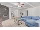 Open-concept living room with wood look tile floors, modern fireplace, and views into the kitchen at 17401 N 16Th Ave, Phoenix, AZ 85023