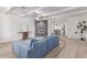 Open-concept living room featuring a sleek fireplace, wood look tile floors and a cozy blue sofa at 17401 N 16Th Ave, Phoenix, AZ 85023