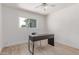 Minimalist office features wood look floors, white walls, large window and work space desk at 17401 N 16Th Ave, Phoenix, AZ 85023