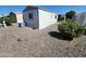 Home exterior shot showcasing gravel landscaping and a compact air conditioning unit at 18026 N Cave Creek Rd # 16, Phoenix, AZ 85032