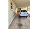 View of carport with painted walls and white vehicle parked on concrete at 18026 N Cave Creek Rd # 16, Phoenix, AZ 85032