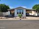 Charming home showcasing a covered carport and well-kept landscaping on a sunny day at 18026 N Cave Creek Rd # 16, Phoenix, AZ 85032