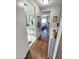 Bright hallway with wood-look floors leads to bathroom and bedroom at 18026 N Cave Creek Rd # 16, Phoenix, AZ 85032