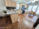 An updated eat-in kitchen has granite countertops, wooden cabinets, and modern appliances at 18026 N Cave Creek Rd # 16, Phoenix, AZ 85032