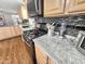 Close up of kitchen featuring gas range, granite countertops, mosaic backsplash and ample cabinet space at 18026 N Cave Creek Rd # 16, Phoenix, AZ 85032