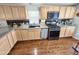The updated kitchen features granite countertops, black appliances, wood cabinets, and tile backsplash at 18026 N Cave Creek Rd # 16, Phoenix, AZ 85032