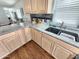 Close up of kitchen with granite countertops, mosaic backsplash, and deep stainless steel sink under a window at 18026 N Cave Creek Rd # 16, Phoenix, AZ 85032