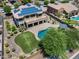Aerial view of backyard oasis featuring pool, covered patio, putting green, and lush landscaping at 18207 W Sells Dr, Goodyear, AZ 85395