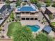 Aerial view of backyard with pool, covered patio, artificial turf, and lush landscaping at 18207 W Sells Dr, Goodyear, AZ 85395
