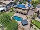 Aerial view of backyard oasis featuring pool, gazebo, artificial turf, and covered patio at 18207 W Sells Dr, Goodyear, AZ 85395