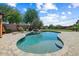 Beautiful backyard with a sparkling pool, rock waterfall, and lush landscaping at 18207 W Sells Dr, Goodyear, AZ 85395