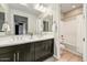 Bathroom featuring a double vanity, framed mirrors, and shower-tub combination at 18207 W Sells Dr, Goodyear, AZ 85395