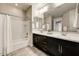 Bathroom with double vanity, tub, and shower at 18207 W Sells Dr, Goodyear, AZ 85395