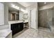 Bathroom with dual sinks, separate shower, vanity, and modern fixtures at 18207 W Sells Dr, Goodyear, AZ 85395