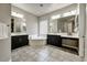 Bathroom featuring dual vanities, a soaking tub, and stylish tile flooring at 18207 W Sells Dr, Goodyear, AZ 85395