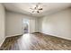 Bedroom featuring wood-look floors and access to a private balcony at 18207 W Sells Dr, Goodyear, AZ 85395