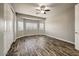 Bedroom with wood-look floors and large windows for natural light at 18207 W Sells Dr, Goodyear, AZ 85395