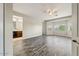 Spacious bedroom with wood-look floors, natural light, and an en-suite bathroom at 18207 W Sells Dr, Goodyear, AZ 85395