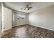 Bedroom with wood-look floors, ceiling fan and natural light at 18207 W Sells Dr, Goodyear, AZ 85395