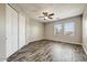 Bedroom with wood-look floors, closet, and bright windows at 18207 W Sells Dr, Goodyear, AZ 85395