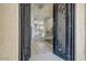 Elegant entryway featuring wrought iron doors opening to the home's interior at 18207 W Sells Dr, Goodyear, AZ 85395