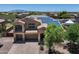Exterior view of home featuring a three car garage, solar panels, and desert landscaping at 18207 W Sells Dr, Goodyear, AZ 85395