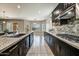 Elegant kitchen with granite countertops, stainless steel appliances, and view to the backyard at 18207 W Sells Dr, Goodyear, AZ 85395