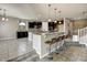 Spacious kitchen with dark cabinetry, granite countertops, large island and tile flooring at 18207 W Sells Dr, Goodyear, AZ 85395