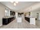 Open kitchen design with island seating and dark wood cabinets with lots of natural light at 18207 W Sells Dr, Goodyear, AZ 85395
