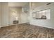 Spacious living room showcasing wood-look floors and a view of the upper level at 18207 W Sells Dr, Goodyear, AZ 85395
