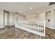 Upstairs loft area featuring white railing overlooking the entry way at 18207 W Sells Dr, Goodyear, AZ 85395