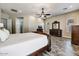 Large main bedroom with wood-look flooring, ceiling fan, and a walk-in closet at 18207 W Sells Dr, Goodyear, AZ 85395