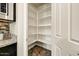 Walk-in pantry with bright white shelving providing ample storage space at 18207 W Sells Dr, Goodyear, AZ 85395