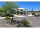 Community playground includes a slide, play structure, shade canopy, and benches surrounded by gravel and plants at 18207 W Sells Dr, Goodyear, AZ 85395
