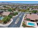 Street view of a neighborhood with homes featuring pools and lush landscaping at 18207 W Sells Dr, Goodyear, AZ 85395