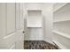 Bright walk-in closet with built-in shelving and hanging rods, offering ample storage space at 18207 W Sells Dr, Goodyear, AZ 85395