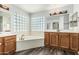 This primary bathroom features double sinks and a relaxing soaking tub at 1847 W Leah Ln, Gilbert, AZ 85233
