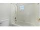 Bright bathroom featuring a bathtub with tile surround and a window for natural light at 1847 W Leah Ln, Gilbert, AZ 85233