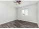 A bedroom with hardwood floors, white walls, a ceiling fan, and a window at 1847 W Leah Ln, Gilbert, AZ 85233
