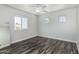 A bedroom with hardwood floors, white walls, and windows at 1847 W Leah Ln, Gilbert, AZ 85233