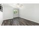 This is a bedroom with hardwood floors, a window, and a ceiling fan at 1847 W Leah Ln, Gilbert, AZ 85233