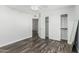 A bedroom with hardwood floors, a closet with sliding doors, fan, and white walls at 1847 W Leah Ln, Gilbert, AZ 85233