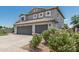 Beautiful two-story home with a three-car garage, desert landscaping, and tile roof at 1847 W Leah Ln, Gilbert, AZ 85233