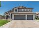 Charming two-story home featuring a three-car garage and tile roof at 1847 W Leah Ln, Gilbert, AZ 85233