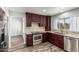 This kitchen features wood-look floors, dark cabinetry and stainless steel appliances at 1847 W Leah Ln, Gilbert, AZ 85233