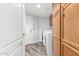 Convenient laundry room featuring modern washer and dryer, storage cabinets, and access to the garage at 1847 W Leah Ln, Gilbert, AZ 85233