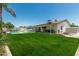 Expansive backyard showcases a pristine pool, covered patio, and a well-maintained lawn at 18820 N 33Rd Ave, Phoenix, AZ 85027
