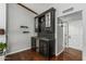 Elegant bar area with custom cabinetry, a wine refrigerator, and stylish tile backsplash, perfect for entertaining guests at 18820 N 33Rd Ave, Phoenix, AZ 85027