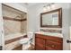Bathroom features a shower over tub combination and a wood vanity with a quartz top at 18820 N 33Rd Ave, Phoenix, AZ 85027
